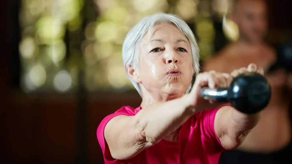 Toning Arms Without the Bulk: Is It Achievable? 1 Woman doing resistance band exercises for toned arms West Malling