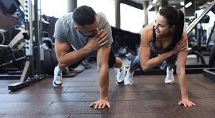 Sculpting Sleek Arms: The Essential Role of Cardio in Toning Without Bulking Up 1 Image of man and woman doing Cardio West Malling to tone their arms.